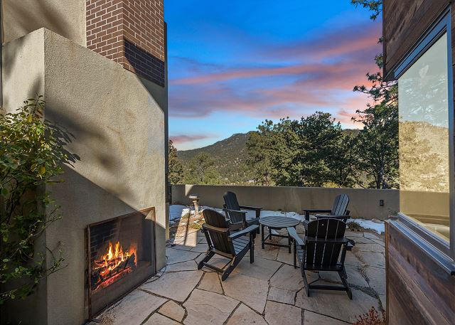 Gorgeous deck with a fireplace and seating 