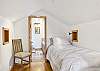Second floor bedroom with two twin beds and ensuite bathroom with deck. 