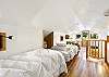 Second floor bedroom with two twin beds and ensuite bathroom with deck. - Please note....stairs are steep to access second level