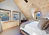 Main bedroom on the second floor with king bed and views of Mammoth Mountain with ensuite bathroom. 