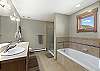 Enusite bathroom to main king bedroom with walk in shower and large soaking tub with dual sinks. 