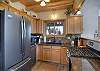 Cozy kitchen with granite countertops and stainless steel appliances.