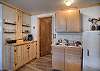 Downstairs living room with small kitchenette space.  No cooking available but coffeemaker (12-cup drop), sink and fridge. 