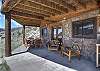 Lower level patio equipped with outdoor table, grill and bar.