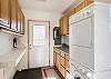 Laundry room/mud room is equipped with a washer and dryer and leads out to the back deck.