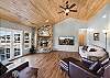 Open living room with gas fireplace, Smart TV and French Doors leading out to the deck with mountain views.