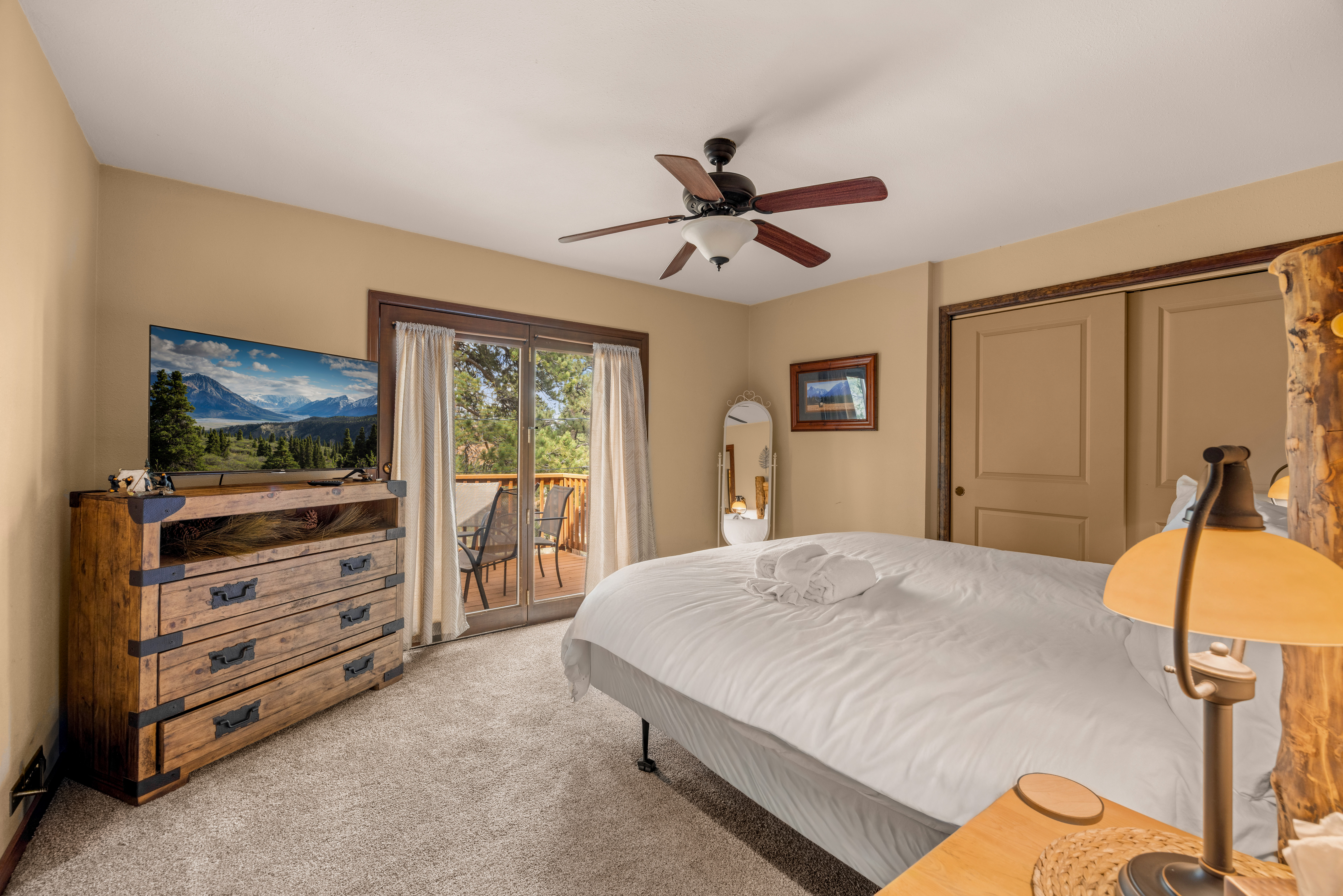 2nd Bedroom (Upper Level): King Bed with smart TV and private deck access