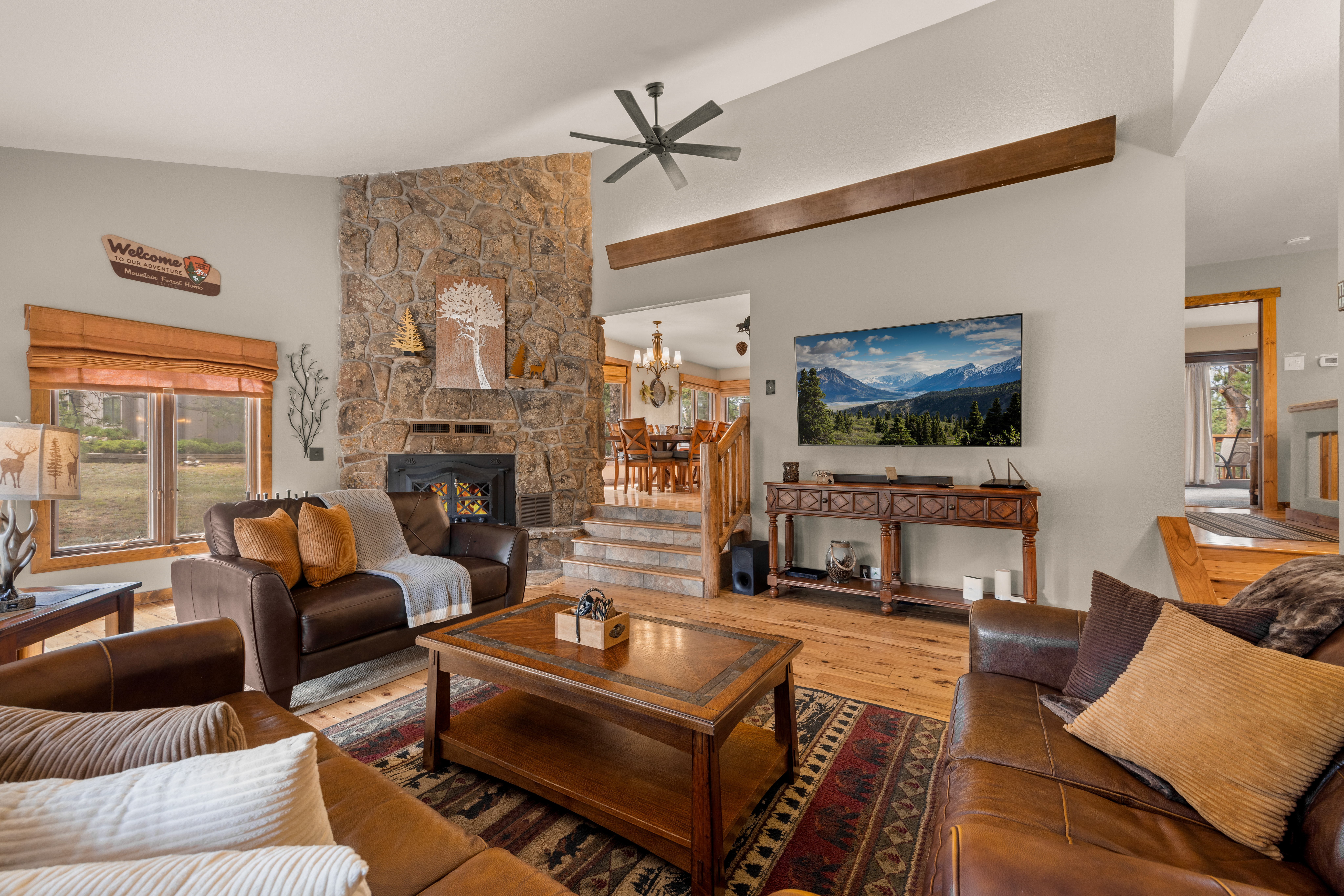 The living room is complete with a smart TV, wood burning fireplace, and room for the whole crew.