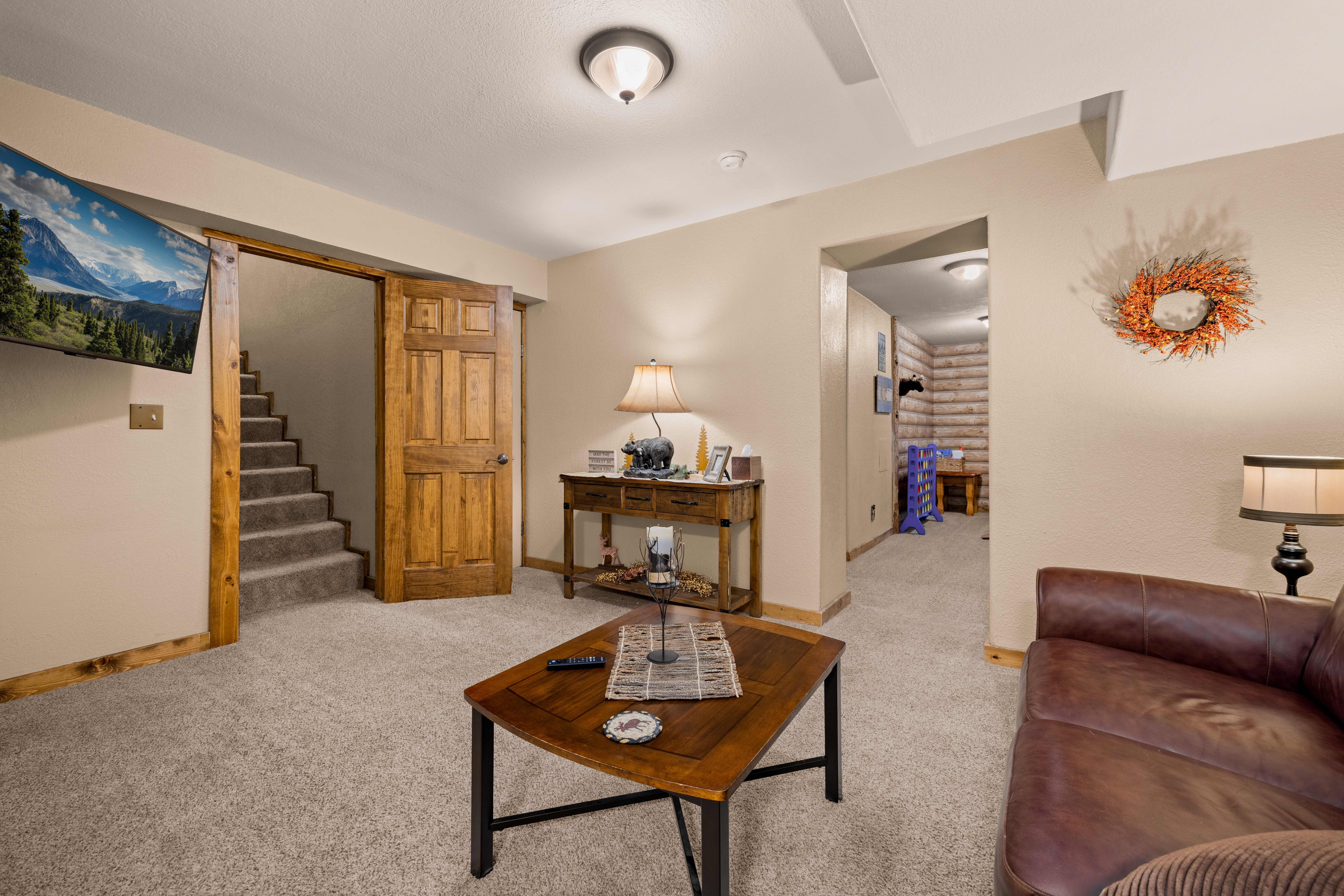 Lower level family room with a smart TV.