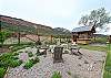 Seating and gas firepit down below in the yard and a bar