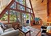 Bright, airy, and inviting—this living room features stunning windows, a fireplace, and Smart TV.