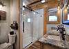 The main king bedroom features an en suite bath with a stand-up shower