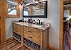 The main bedroom features a king bed and an en suite bathroom with dual vanities