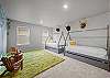 Two twin beds located in the kid's room, with two trundle beds underneath (4 twin beds total)