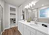 Primary Bathroom with dual sinks and walk in shower