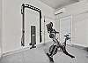 Get your workout on in the Gym! Completed with a Peloton and weight rack