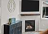 Main living area complete with gas fireplace and 65 inch smart TV.