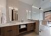 Master bathroom with dual sinks and soaking tub/wet room