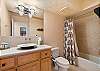 Spacious bathroom with tub and shower combo for added flexibility.
