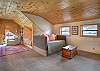Open loft on the second floor featuring a day bed and a cozy twin nook bed.