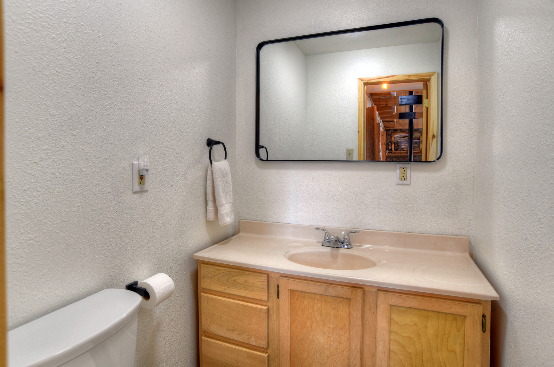 Main level 1/2 bathroom off living area. 
