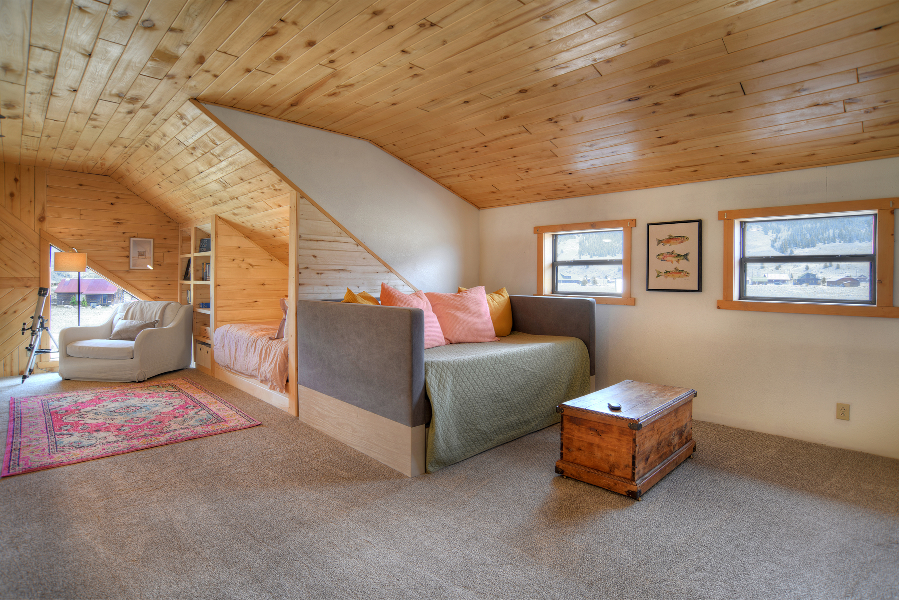 Open loft on the second floor featuring a day bed and a cozy twin nook bed.