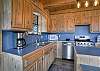Open-concept living area featuring a fully equipped kitchen with stainless steel appliances, and a dining area with plenty of seating.