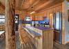 Open-concept living area featuring a fully equipped kitchen with stainless steel appliances, and a dining area with plenty of seating.