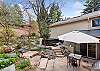 Large yard with BBQ, hot tub, and seating