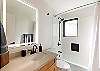 Spacious bathroom with tub and shower combo for added flexibility.

