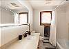 Clean and functional bathroom featuring a tub/shower combination.
