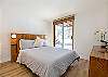 Bright and clean queen bedroom, perfect for a comfortable stay.
