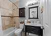 Clean and functional bathroom featuring a tub/shower combination.
