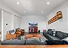 Lounge area with foosball table, seating, and a Smart TV