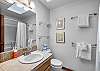 Spacious bathroom with tub and shower combo for added flexibility.
