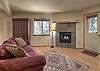 Lower level living room with Queen sleeper sofa and its own fireplace