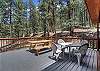 Private deck with comfortable seating and serene wooded views