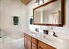 Full bathroom featuring a sleek walk-in shower and a jetted tub
