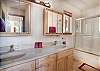 Spacious bathroom with tub and shower combo for added flexibility.
