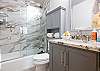 Spacious bathroom with tub and shower combo for added flexibility.
