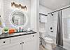 Spacious bathroom with tub and shower combo for added flexibility.

