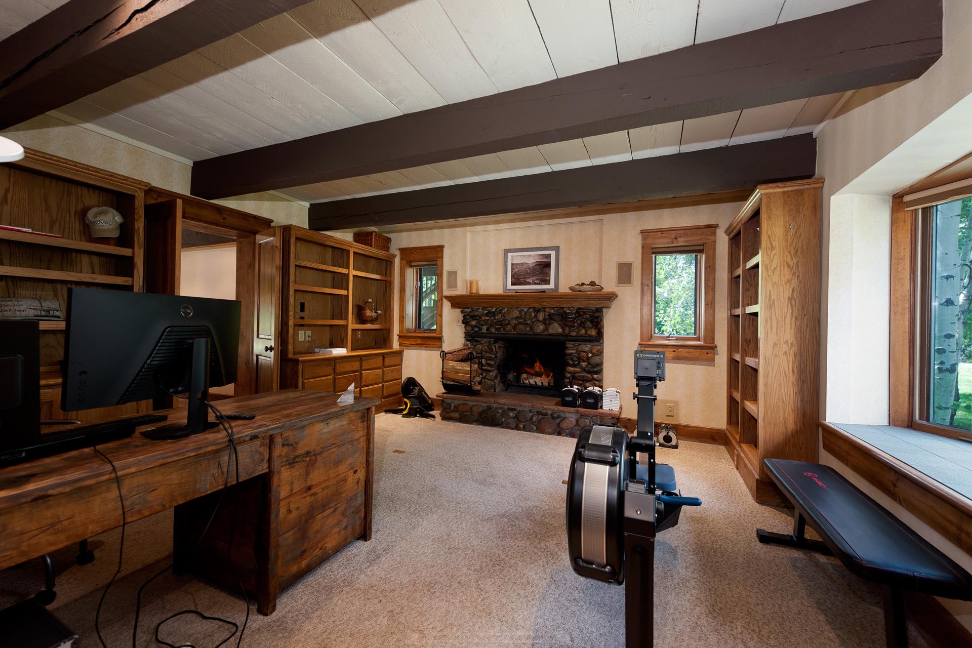 Addional room wiht a desk (and cool stone fireplace)