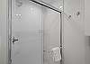 Fresh and functional full bathroom with a walk-in shower and contemporary design.
