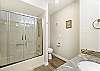 Main level king bedroom ensuite bathroom with tub/shower combo and granite countertops. 