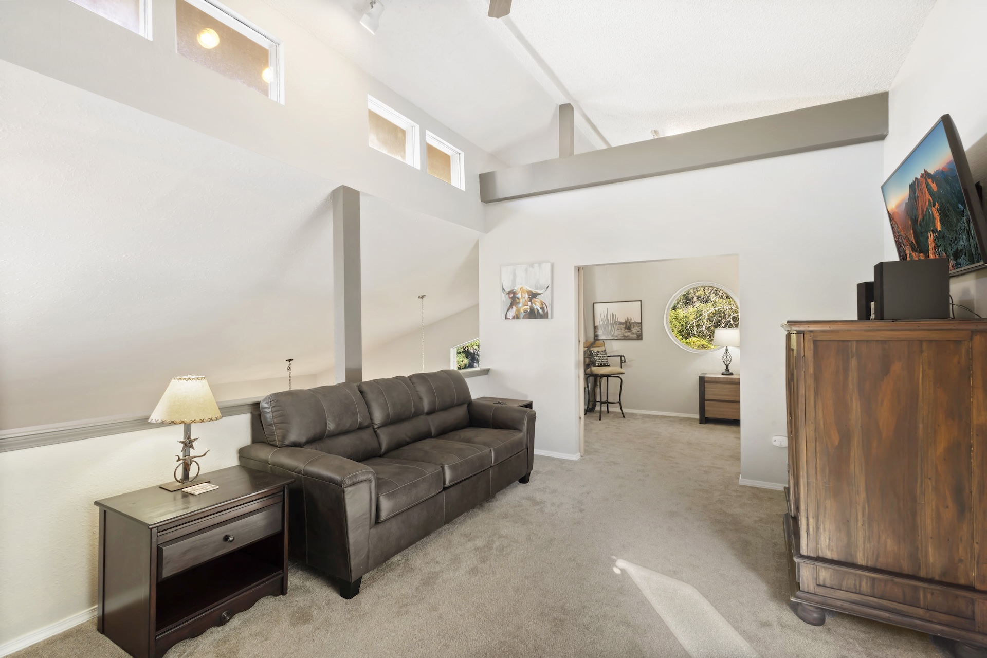 Upstairs loft area with Smart TV and sleeper sofa, open to the living room below.
