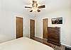 Main level king bedroom with ensuite bathroom, Smart TV and back patio access. 