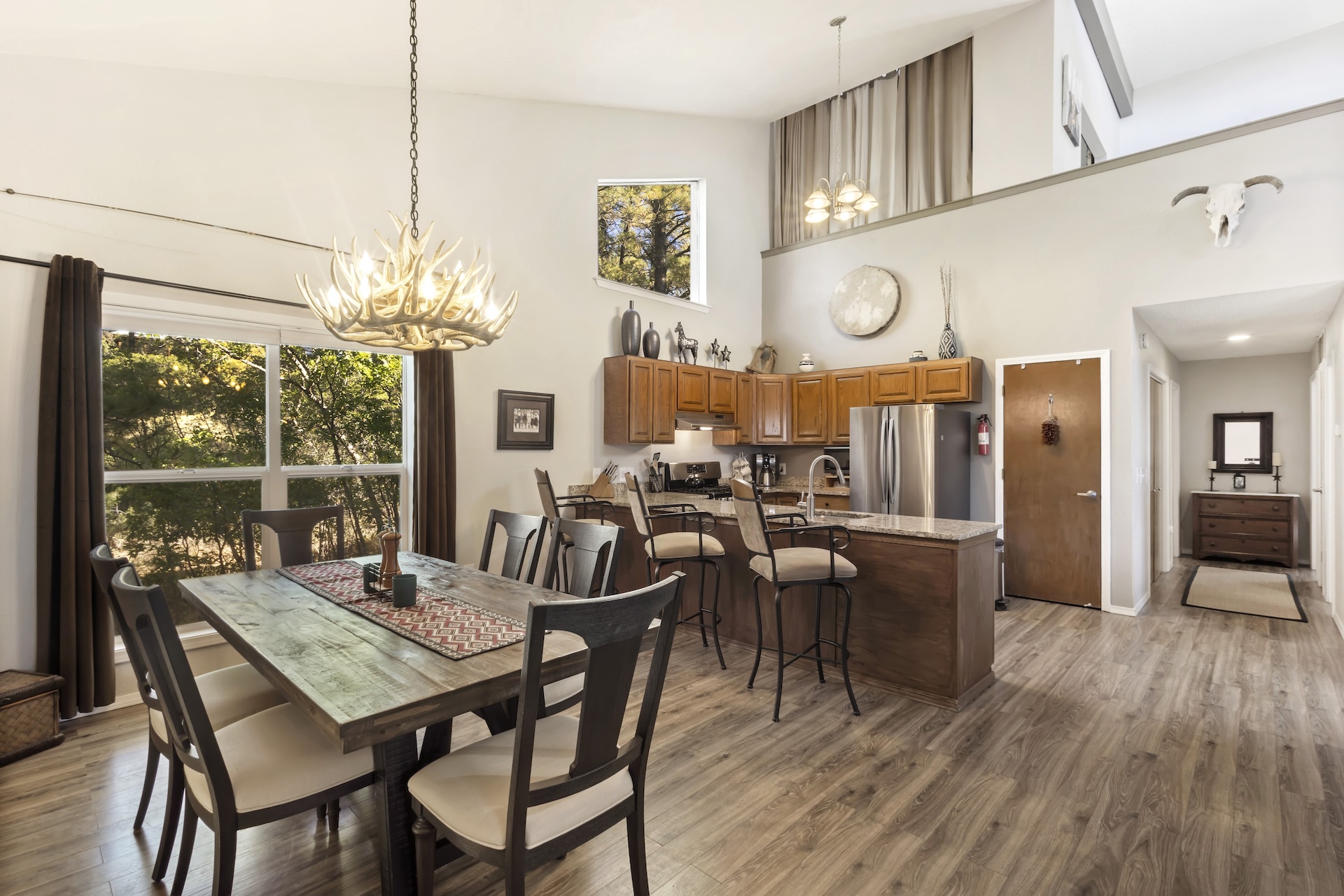 Fully equipped galley kitchen with stainless steel appliances, granite countertops. Open to the dining area and living room.