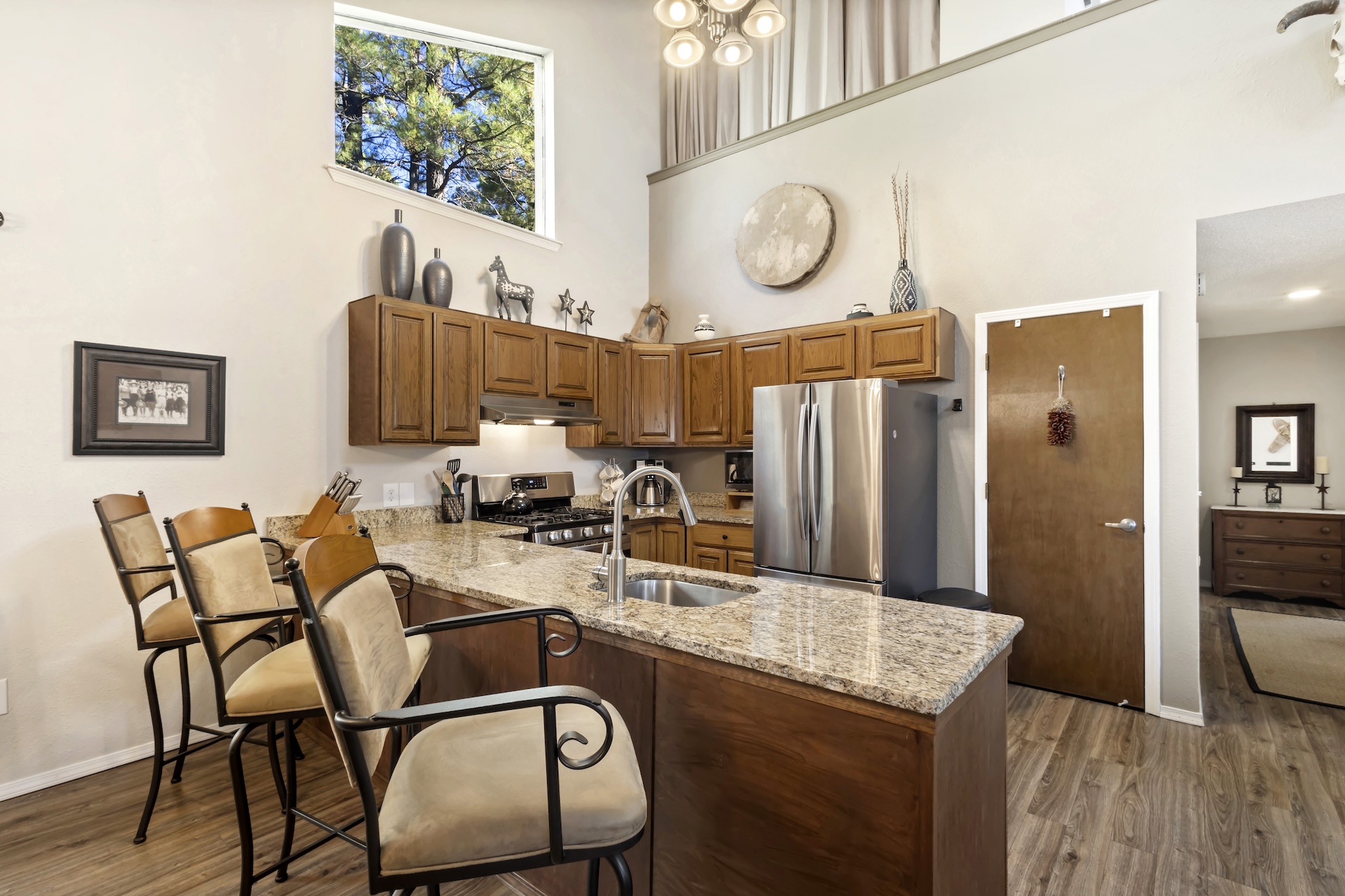 Fully equipped galley kitchen with stainless steel appliances and granite countertops.