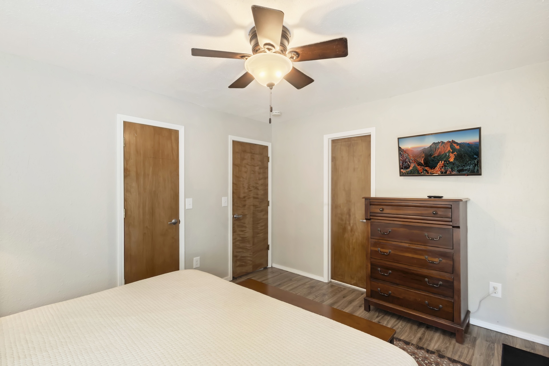 Main level king bedroom with ensuite bathroom, Smart TV and back patio access.