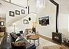 Living room with gas fireplace, smart TV and mini fridge.  Open to kitchen and dining. 